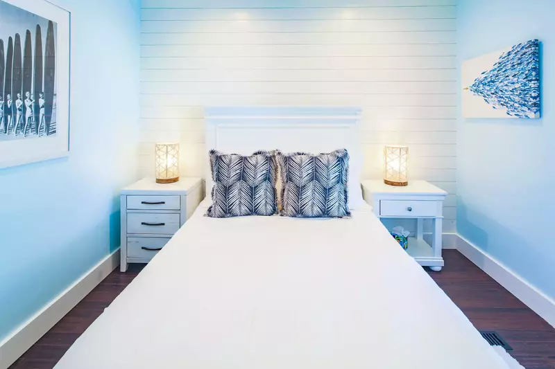 The queen bedroom features a queen bed and night stands with reading lamps.