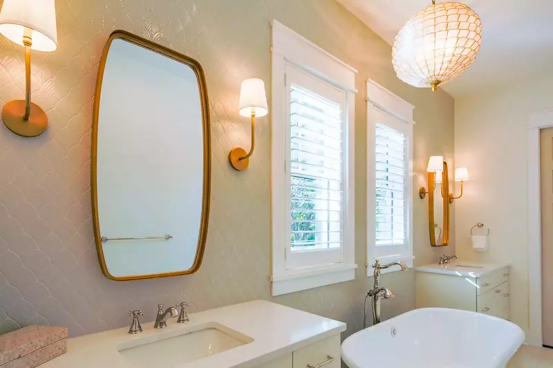 The en suite bathroom features two vanities and a soaking tub.
