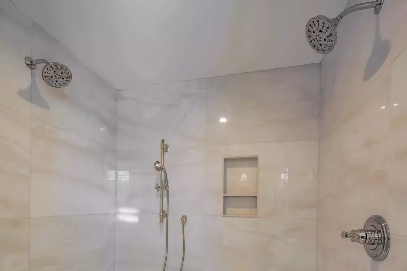 The walk-in shower in the primary bathroom has three shower heads.