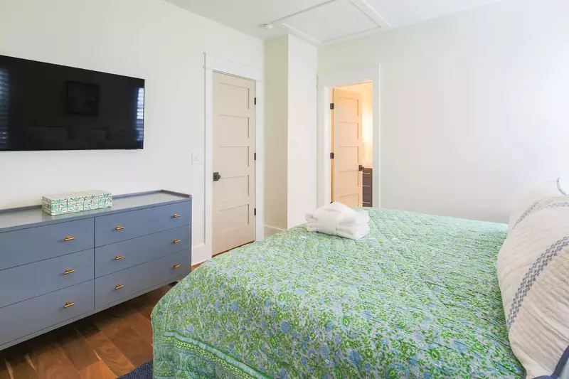 The upstairs king suite also has a dresser, wall-mounted TV and en suite bathroom.