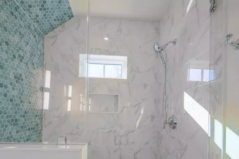 The en suite bathroom also has the gorgeously-tiled, walk-in shower.