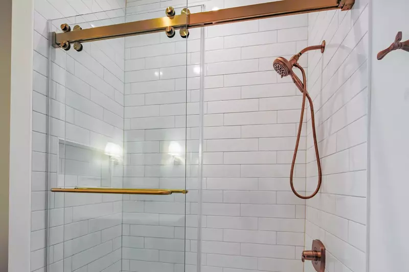 This bathroom featuers a tiled, shower/tub combo.
