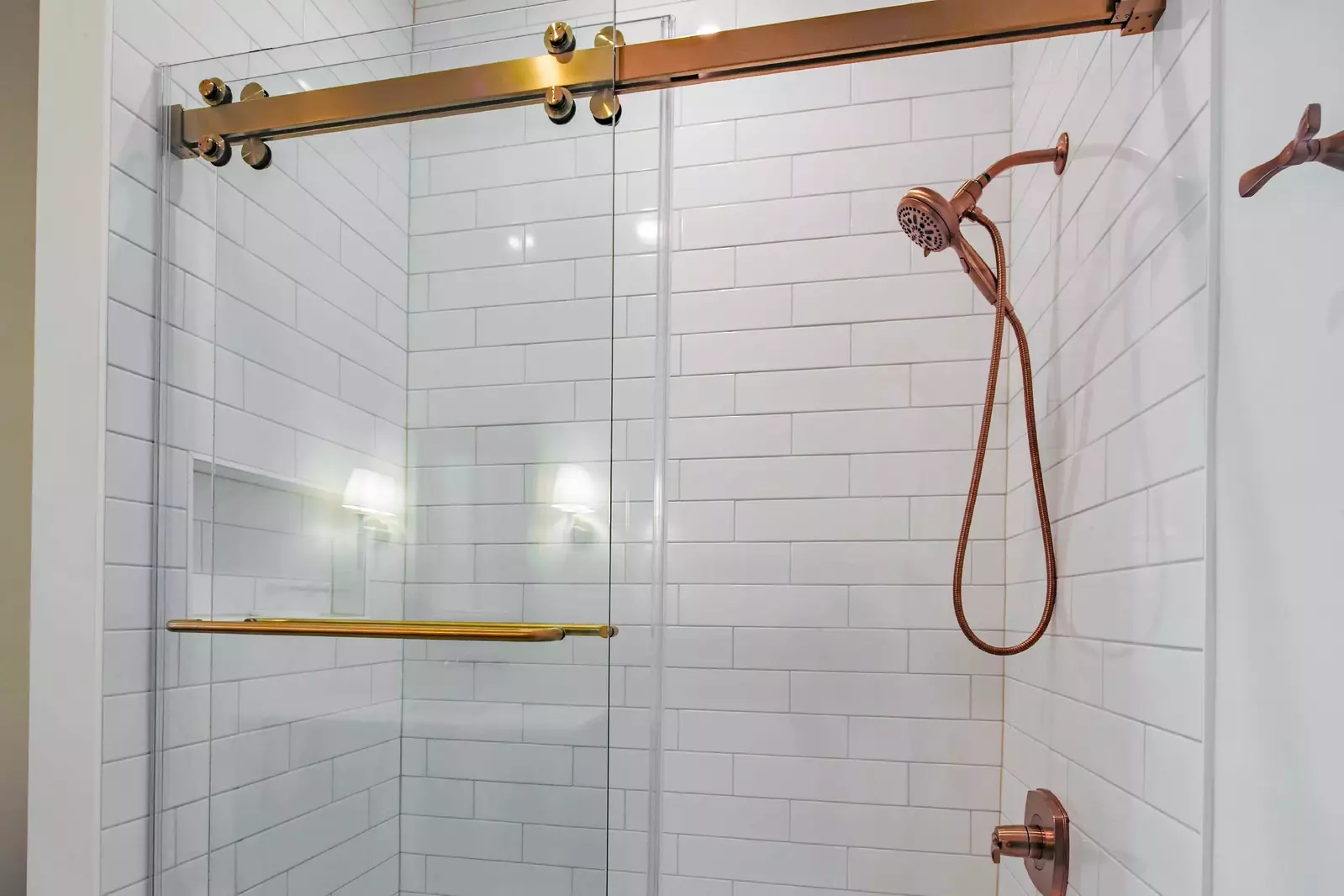 This bathroom featuers a tiled, shower/tub combo.