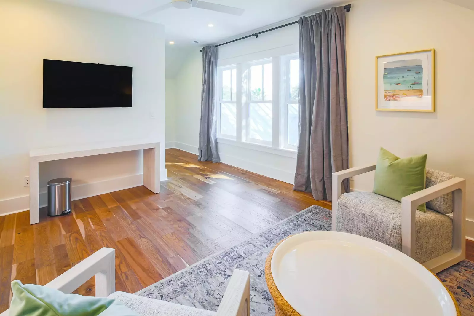 The family room also features a wall-mounted TV and lovely natural light.