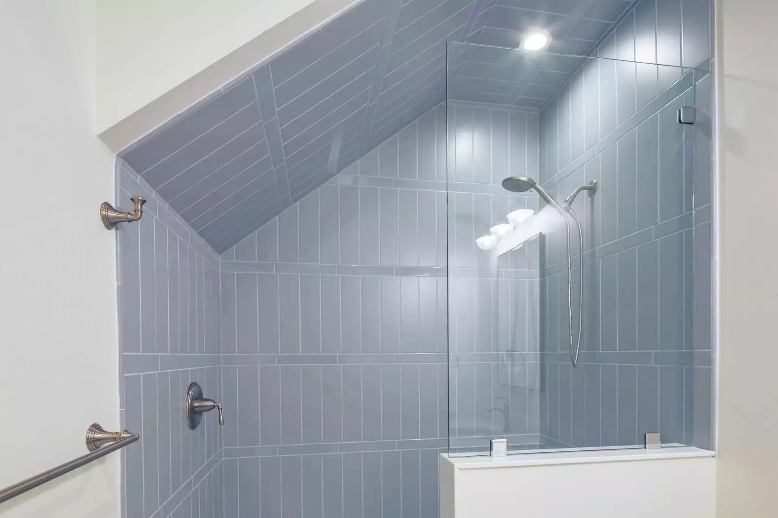 This en suite bathroom also has a beautifully tiled, walk-in shower.