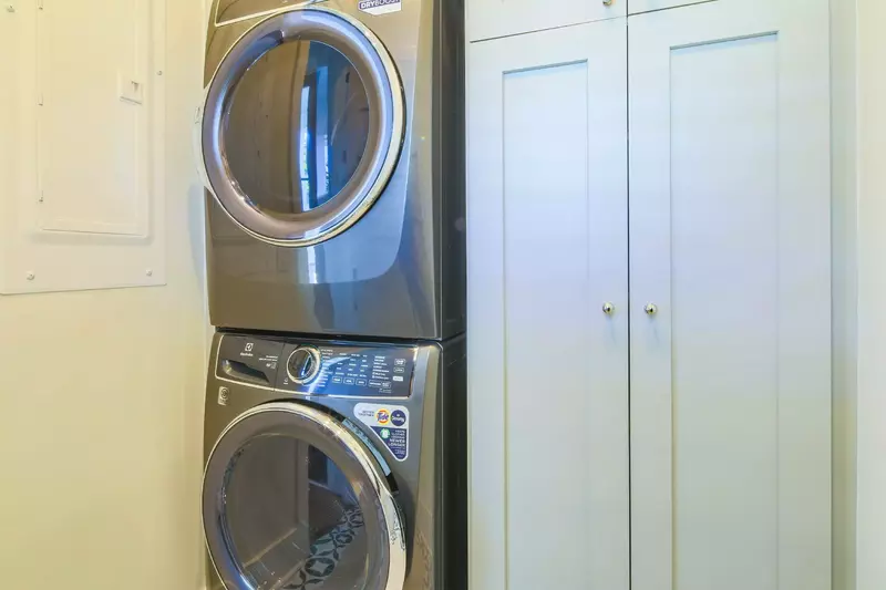 The full-sized washing machine and dryer are located on the lower level near the primary suite.