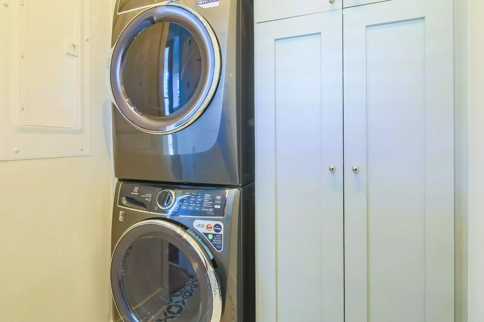 The full-sized washing machine and dryer are located on the lower level near the primary suite.