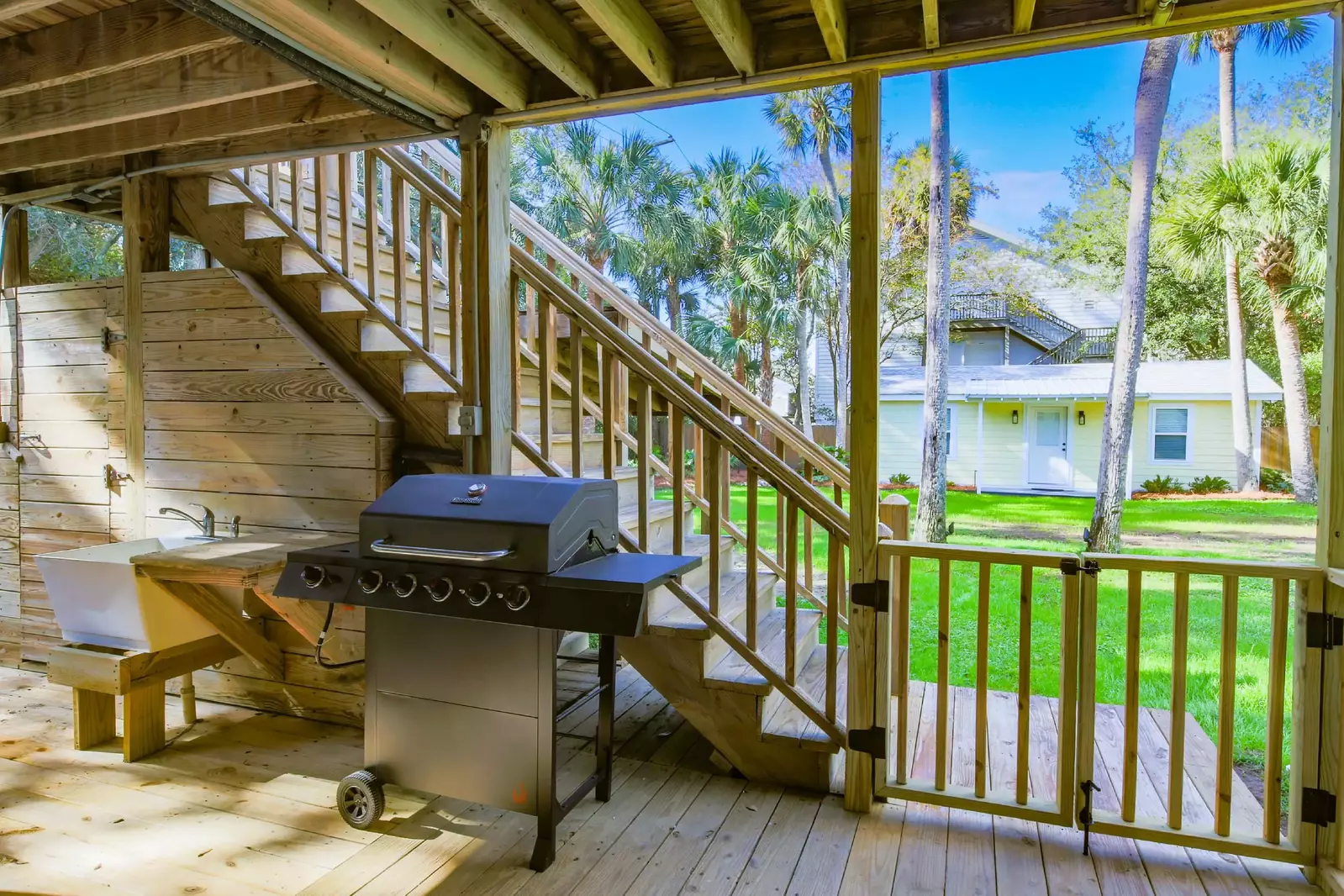 There is also a gas BBQ grill and utility sink on the covered deck.  The staircase provides backyard access to the upstairs unit in the duplex.