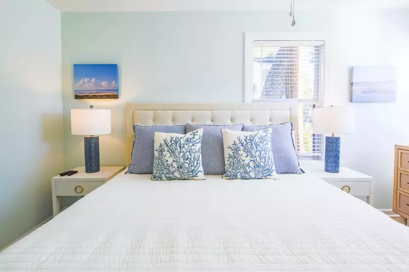 The master suite features a king bed and night stands with reading lamps.
