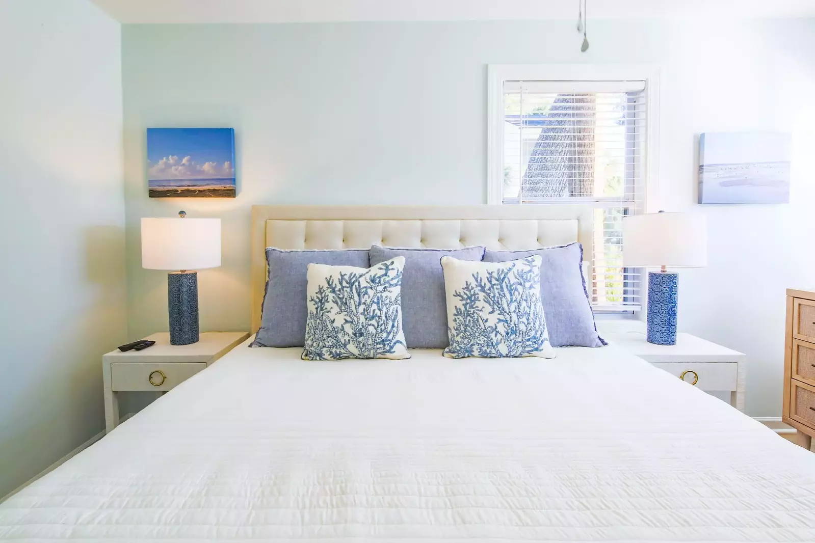 The master suite features a king bed and night stands with reading lamps.