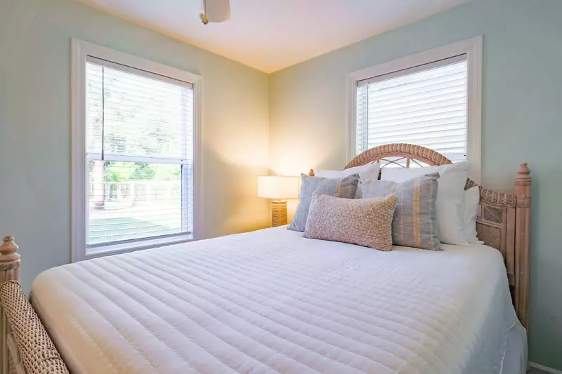 The queen bedroom looks out onto the home's backyard.