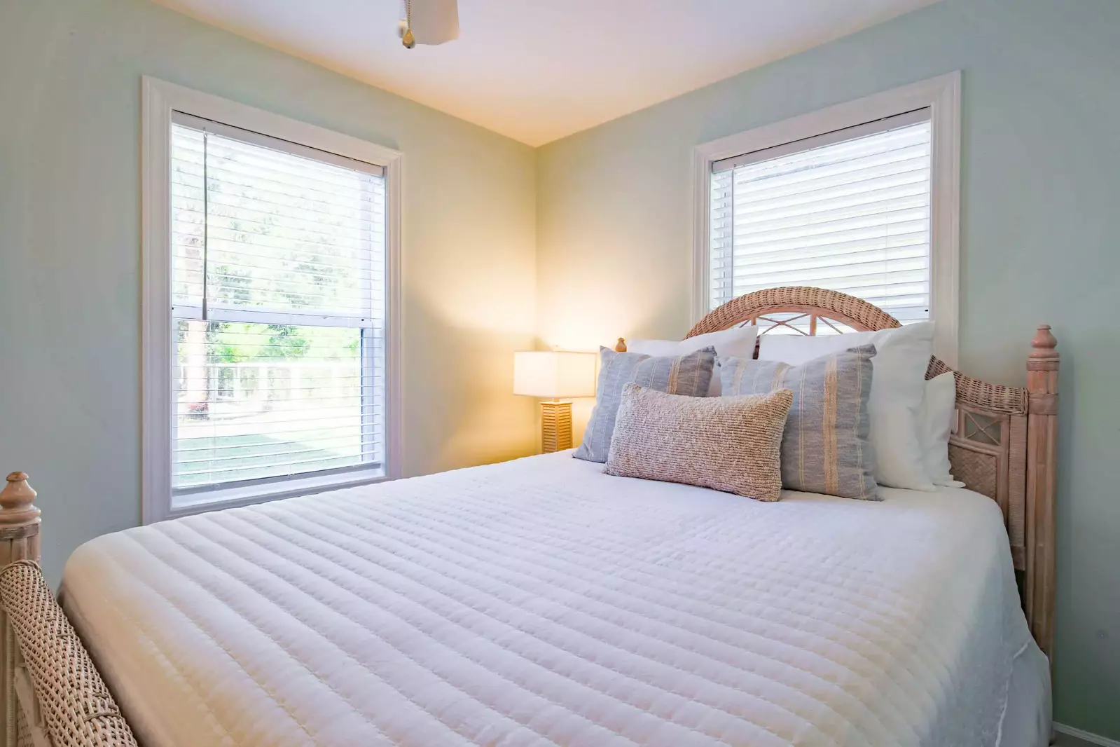 The queen bedroom looks out onto the home's backyard.