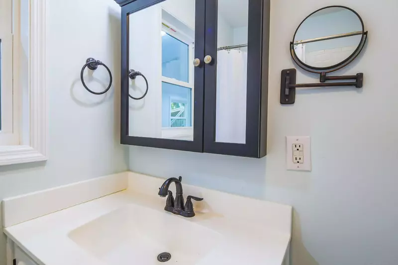 This bathroom features a spacious vanity and medicine cabinet.