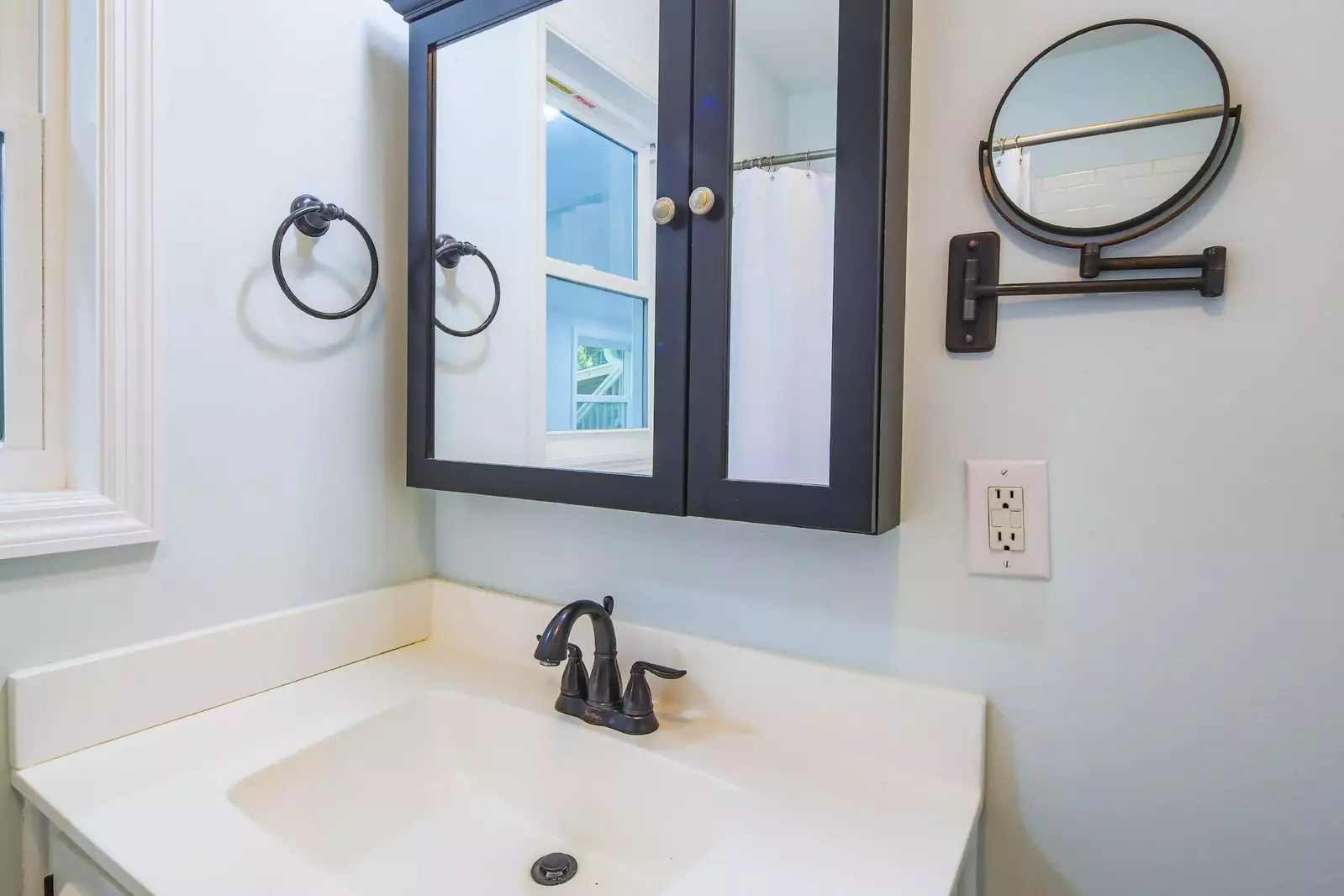 This bathroom features a spacious vanity and medicine cabinet.