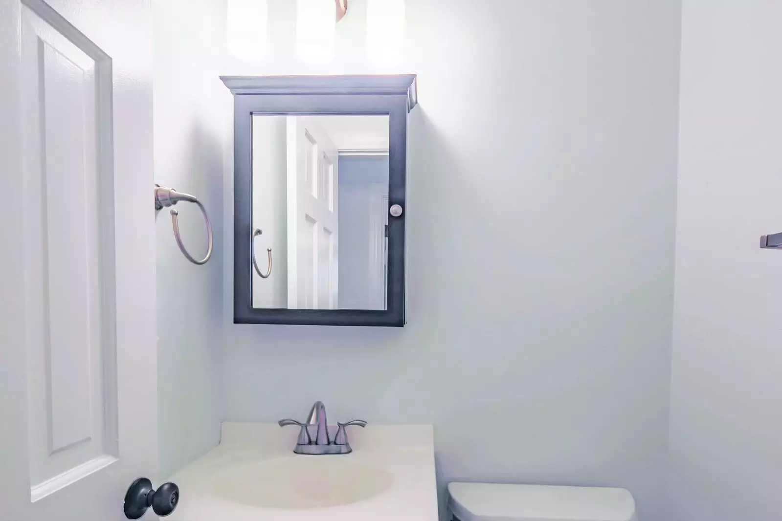 The half bathroom near the bedrooms features a vanity and toilet.