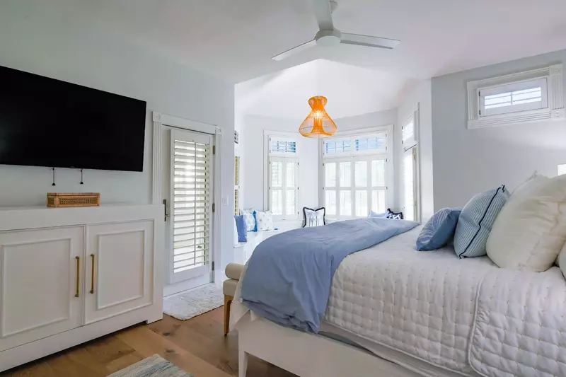 The master suite features wonderful natural light and access to a private sunroom.