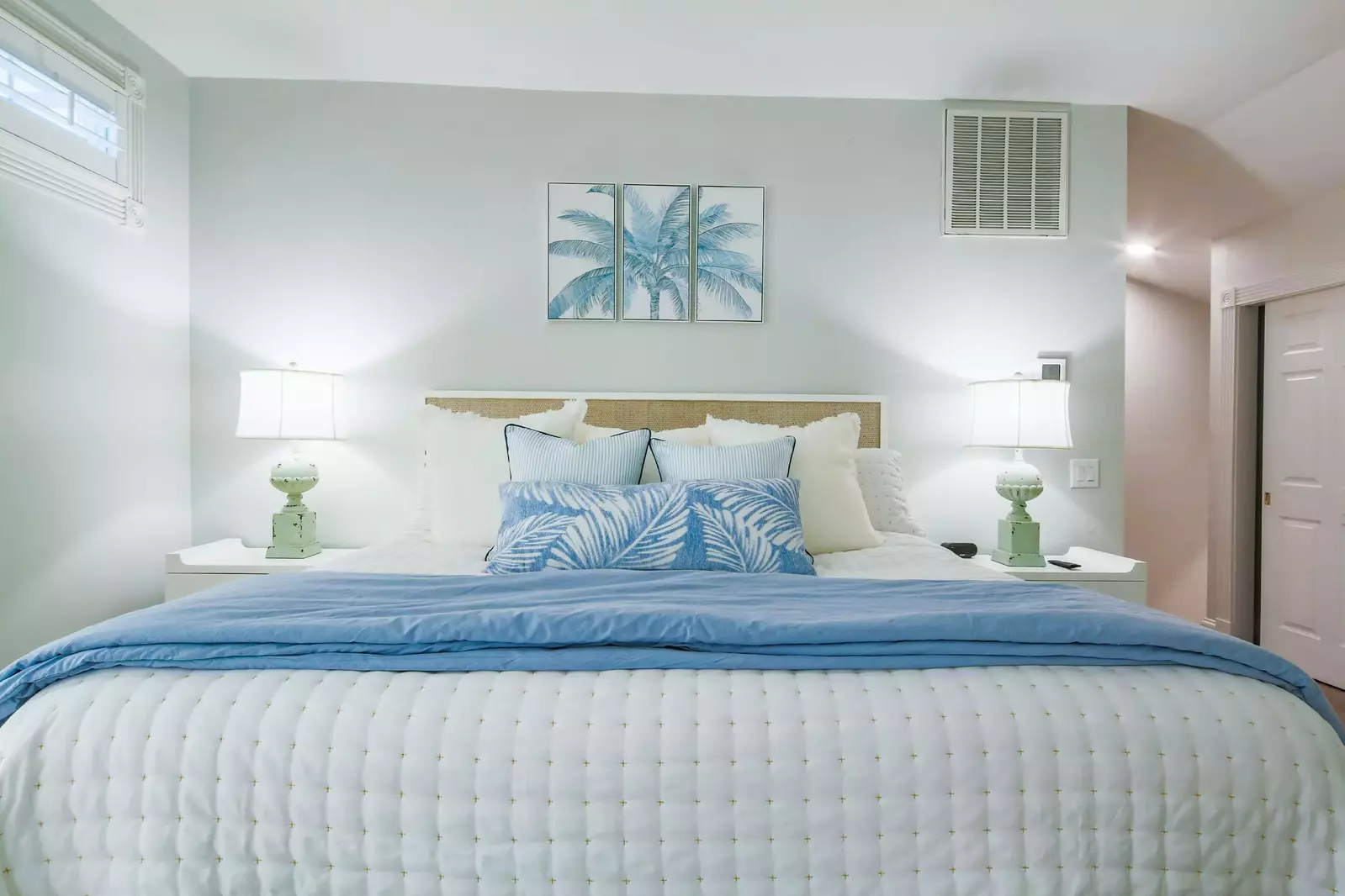 The master suite also has night stands and reading lamps on both sides of the king bed.
