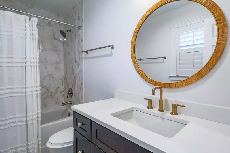 The en suite bathroom features a spacious vanity and a tiled shower/tub combo.