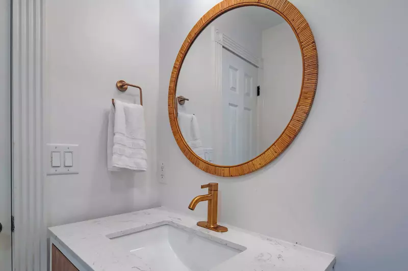 This hallway bathroom features a beautiful vanity.