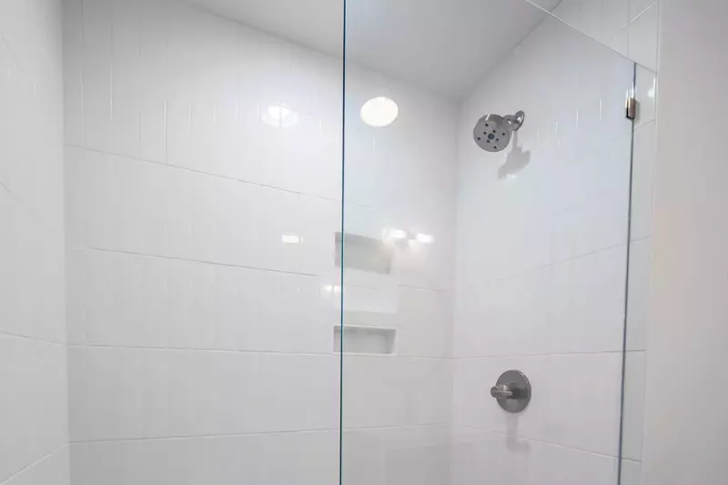 The hallway bathroom also has a tiled, walk-in shower.
