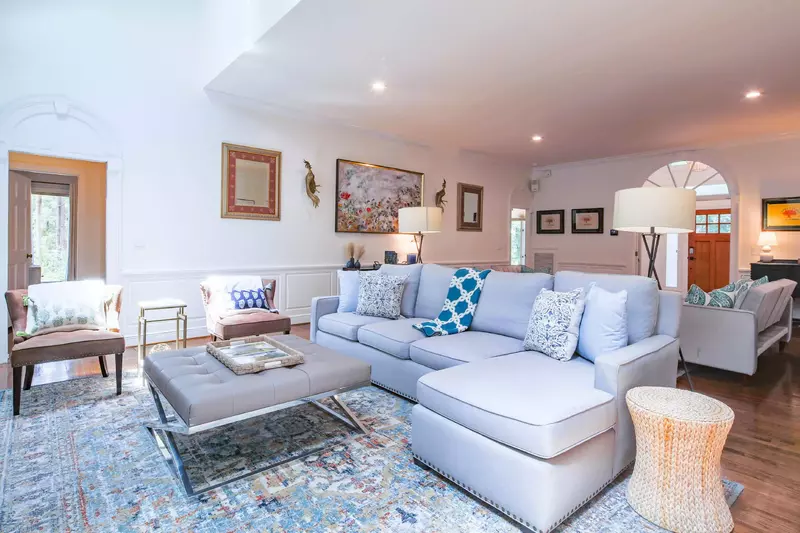 The arched accents, wainscoting, half moon windows and furnishings create an elegant yet comfortable home.