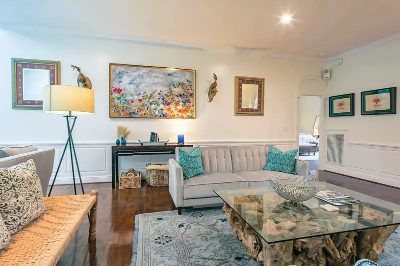 The master suite is located off of the living room through the door on the right in this photo.