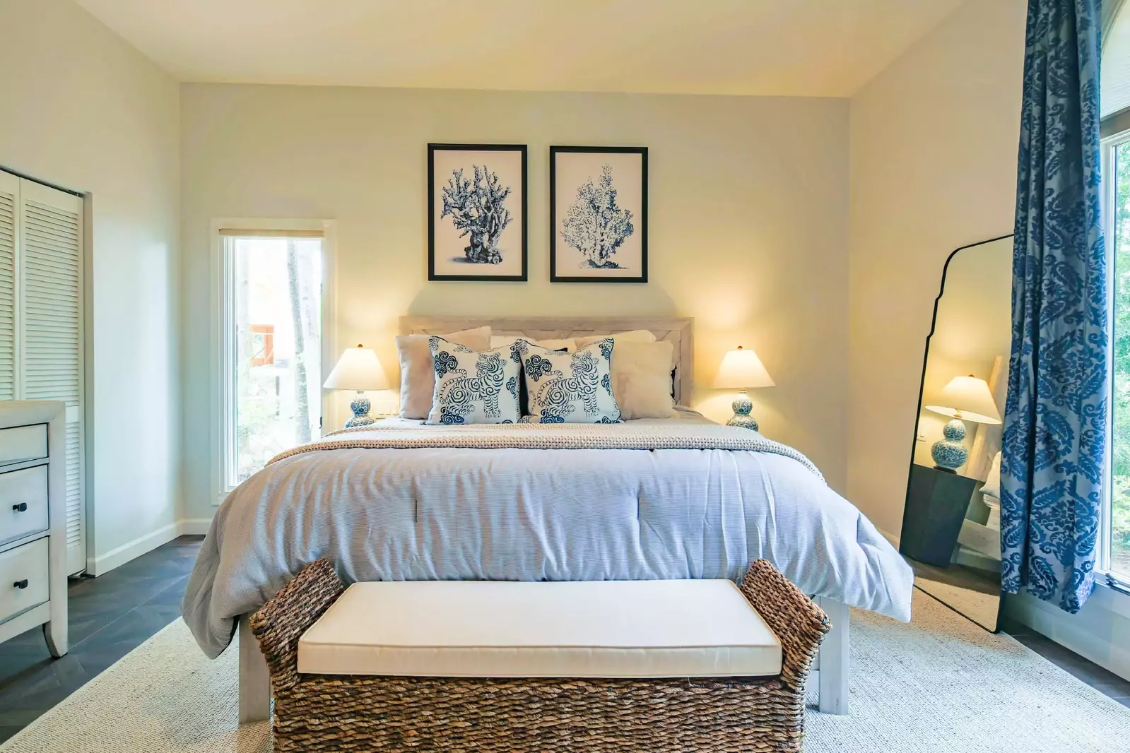 The master suite features a king bed, night stands with reading lamps and his & her bathrooms.