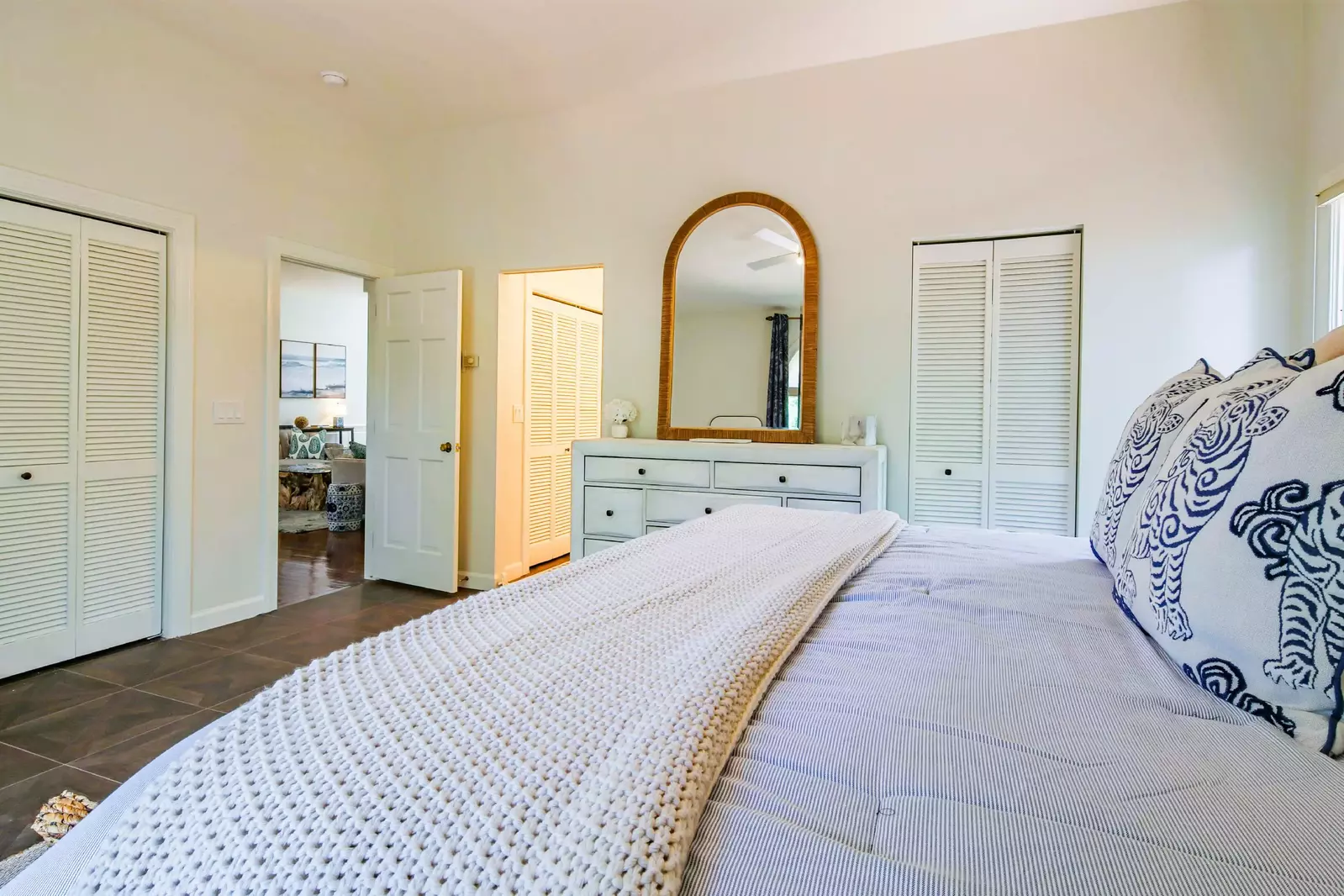 The doorways on both sides of the dresser lead to the his & her bathrooms.