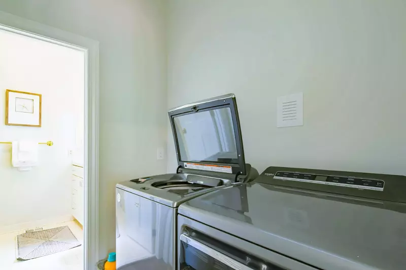 There is a full-sized washing machine and dryer located within the home.