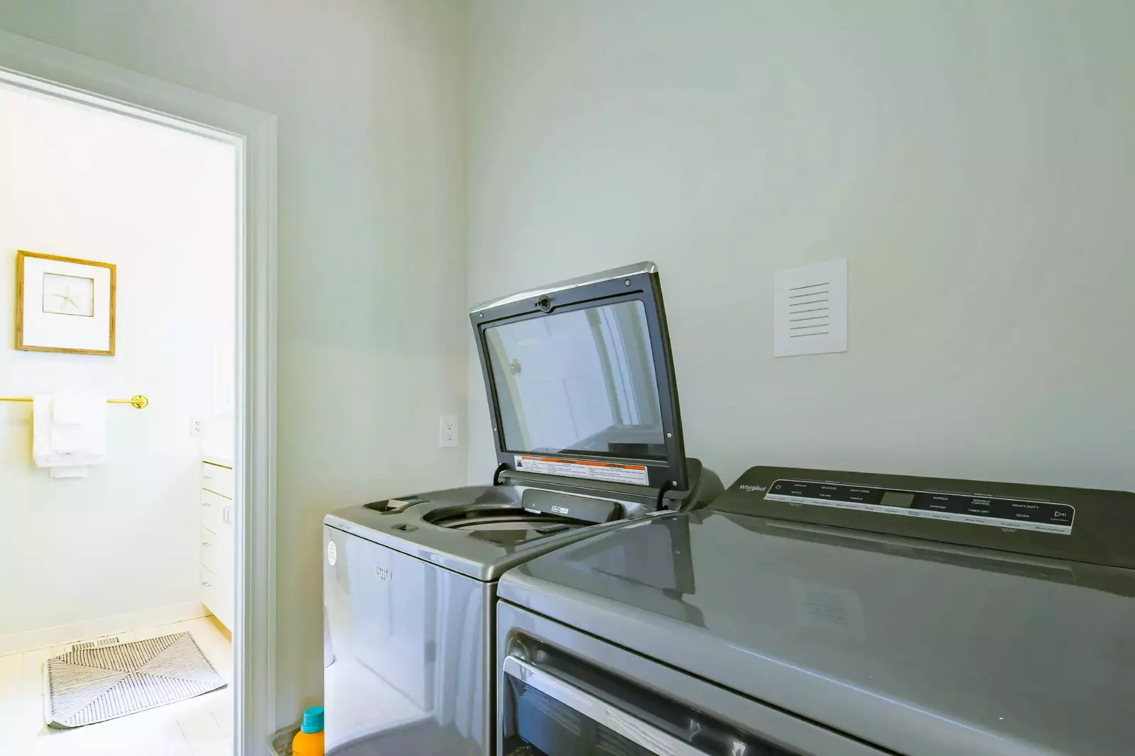 There is a full-sized washing machine and dryer located within the home.