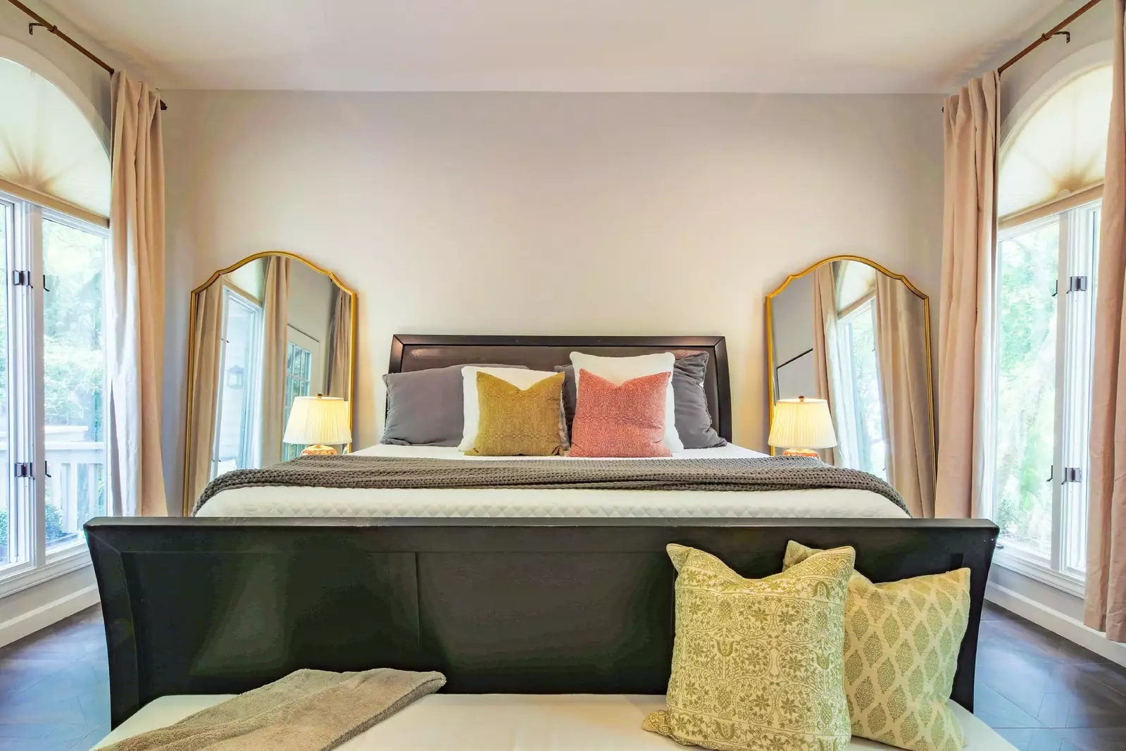 This guest bedroom features a king bed, night stands with reading lamps and lovely natural light.