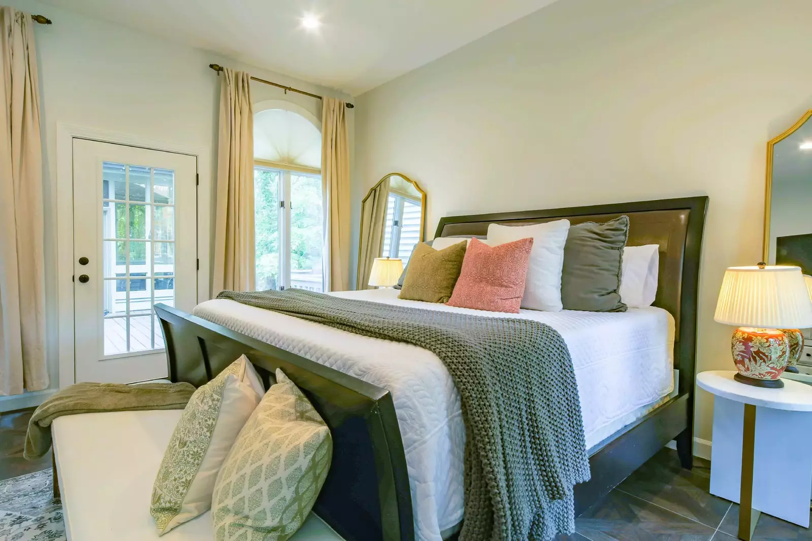This guest bedroom has access to the home's back deck.