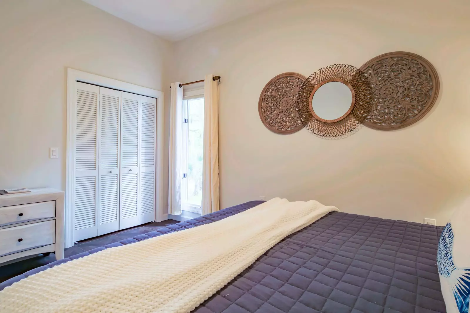 There is a dresser and closet within this guest bedroom.