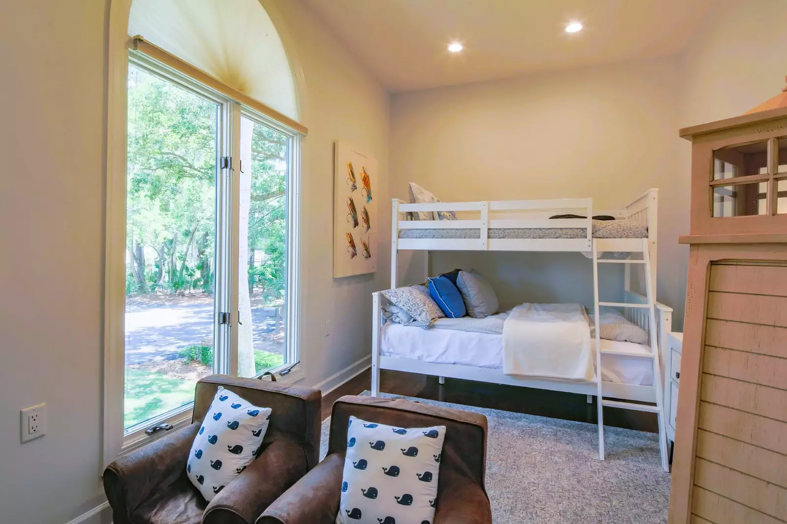 The bunk bedroom looks out onto the front yard of the home.