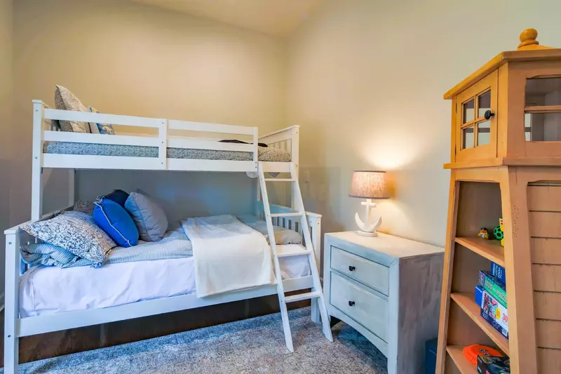 The bunk bedroom features a full bed on the bottom bunk and a twin bed on the top bunk.