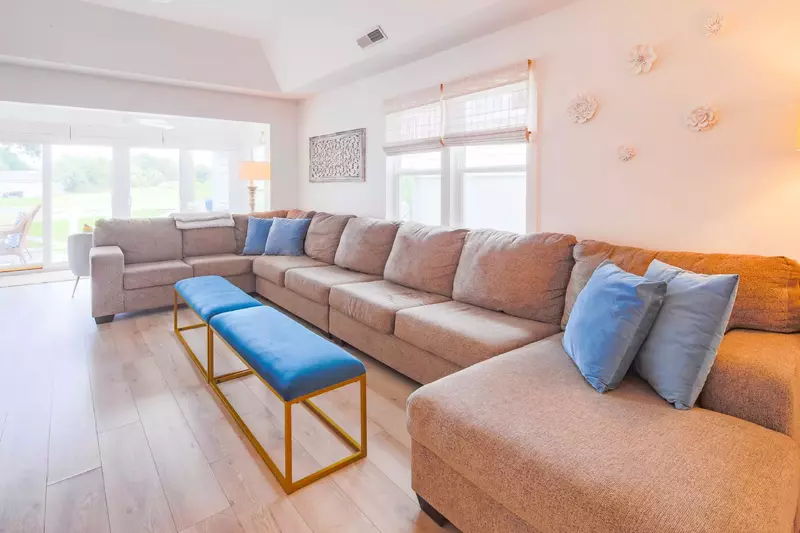 The Beach Cove features a comfortable living room with a large sectional.