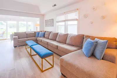 The Beach Cove features a comfortable living room with a large sectional.