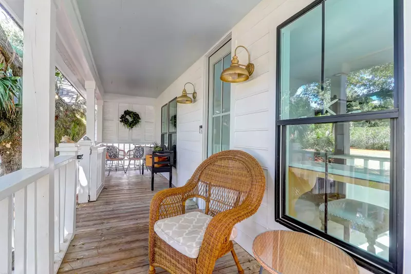 You will be greeted by this lovely front porch with seating area when you arrive at the home.