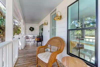 You will be greeted by this lovely front porch with seating area when you arrive at the home.