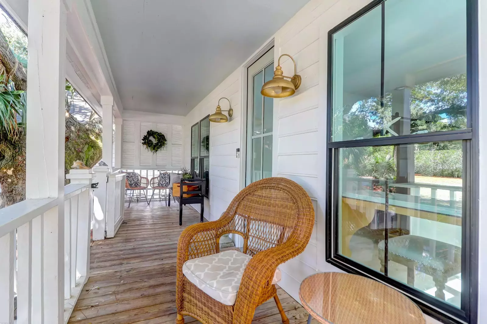 You will be greeted by this lovely front porch with seating area when you arrive at the home.
