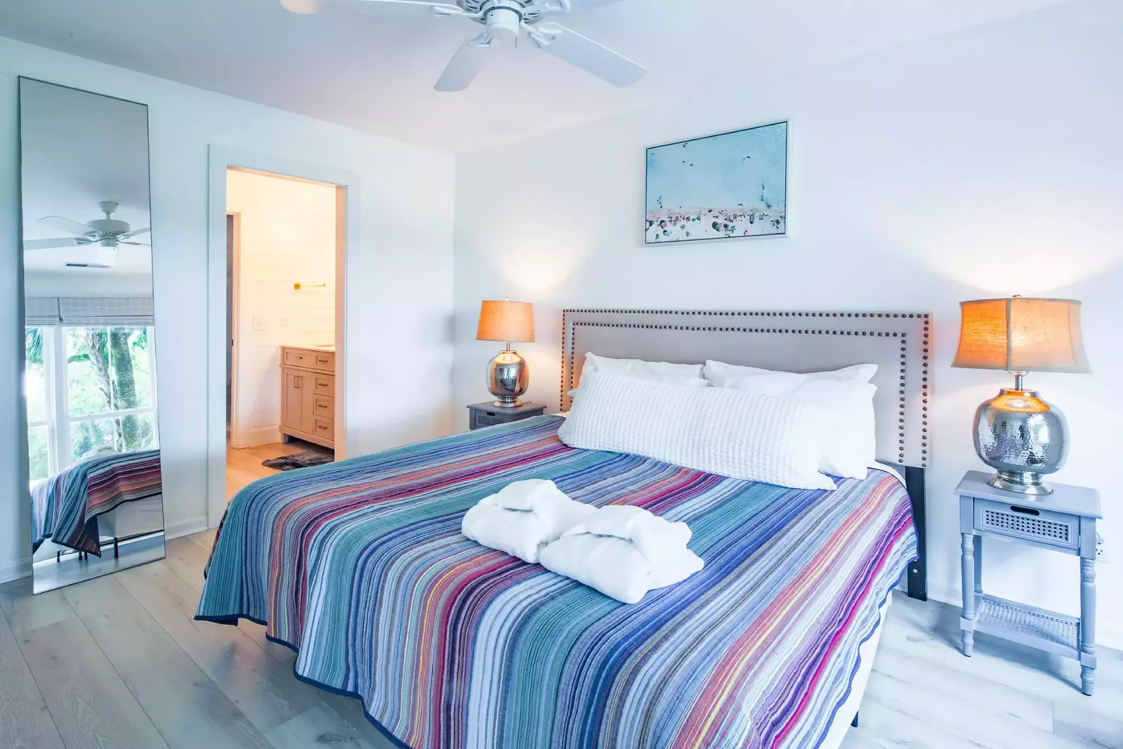 The master suite also has a full length mirror, ceiling fan and en suite bathroom.
