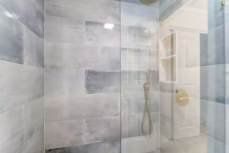The en suite bathroom also has a tiled, walk-in shower.