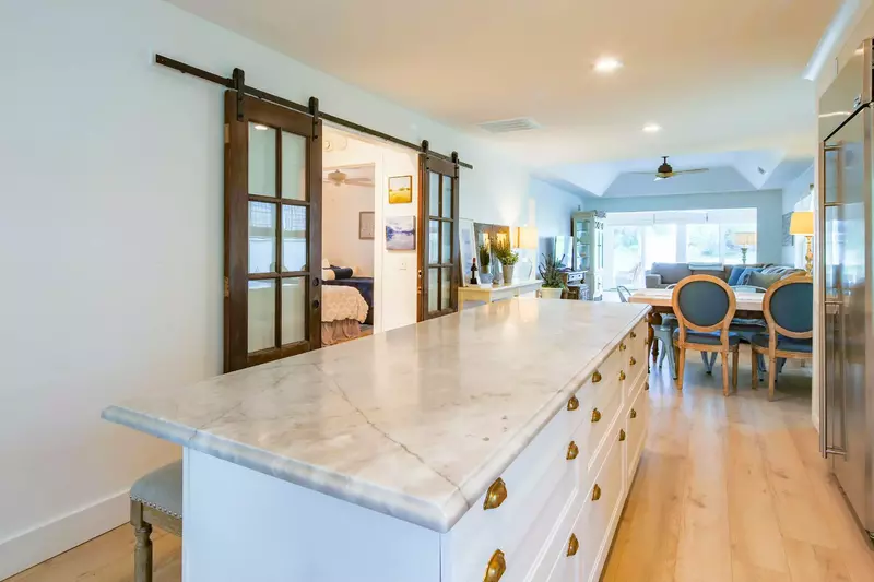 The home's other two bedrooms are located through the barn doors near the kitchen.