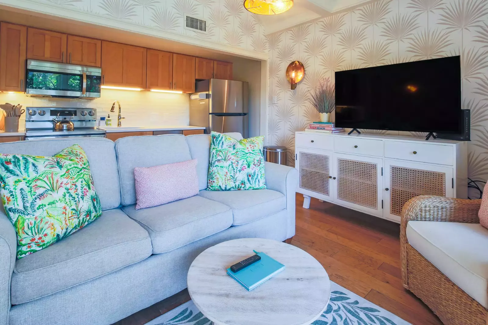 This room features a kitchen, living room and large screen TV.