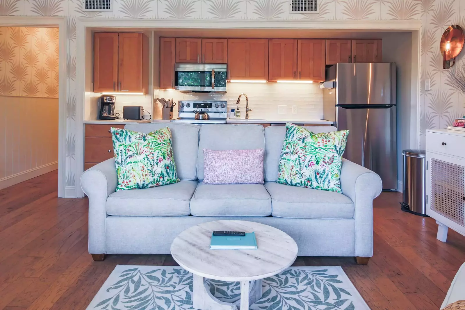 This room features a kitchen, living room and dining area.