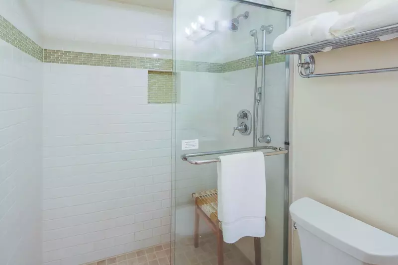 The bathroom also has a tiled, walk-in shower with two shower heads.