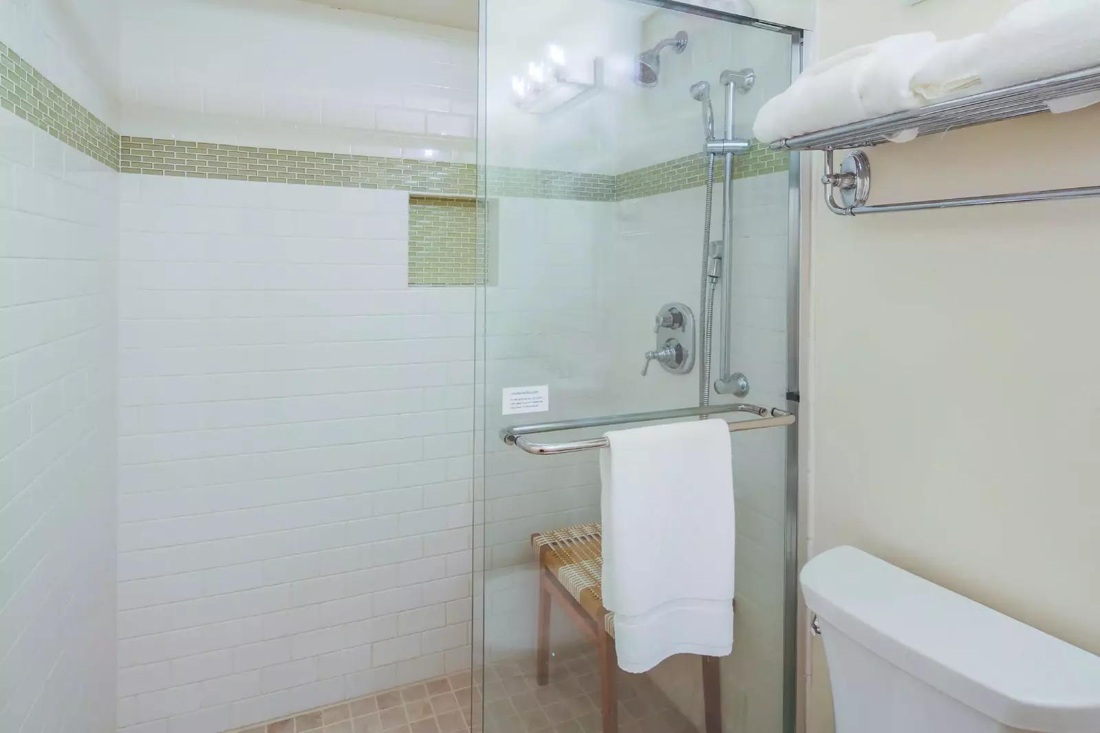 The bathroom also has a tiled, walk-in shower with two shower heads.