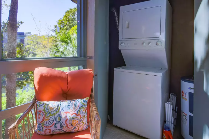 There is a stacked washing machine and dryer on the screened porch.