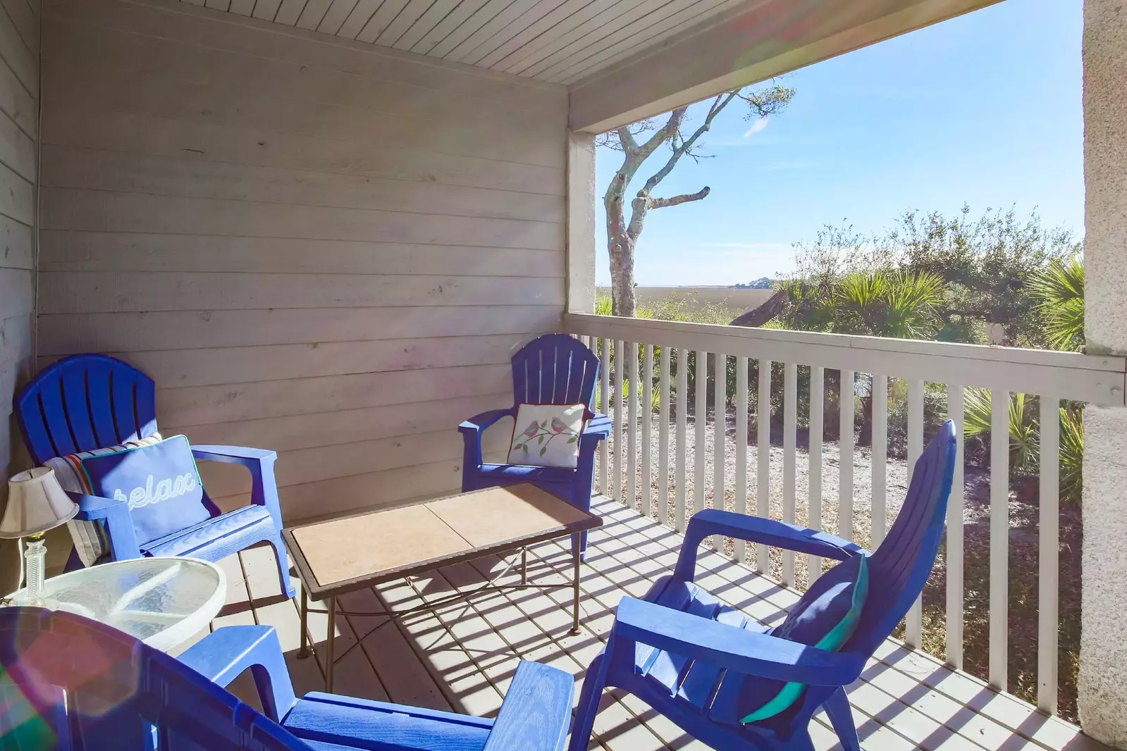 The partially covered back deck features glorious views of the marsh and glimpses of the ocean (to the left).