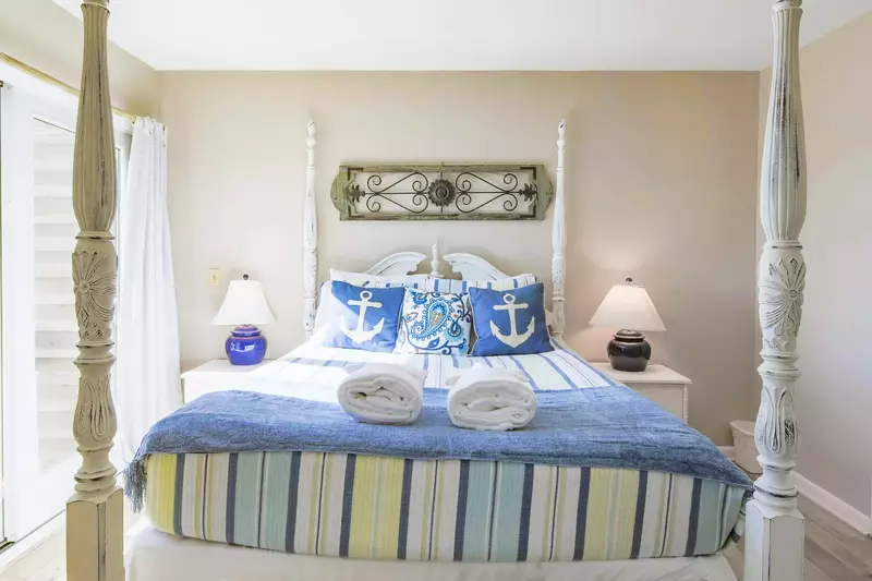 The master suite also features two night stands with reading lamps.
